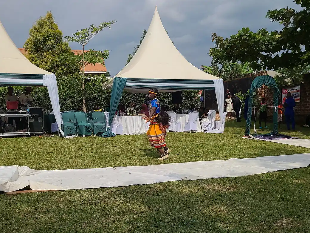 White event tents pitched on a garden lawn