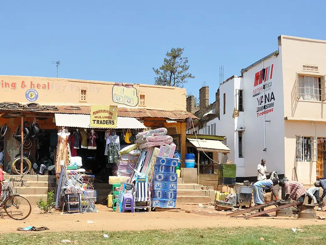 A row of small shops with goods displayed out on the pavement