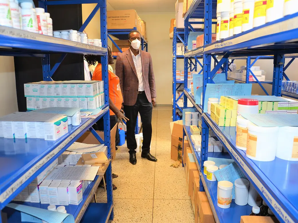 Blue shelving racks stocked with medical supplies in a drug store